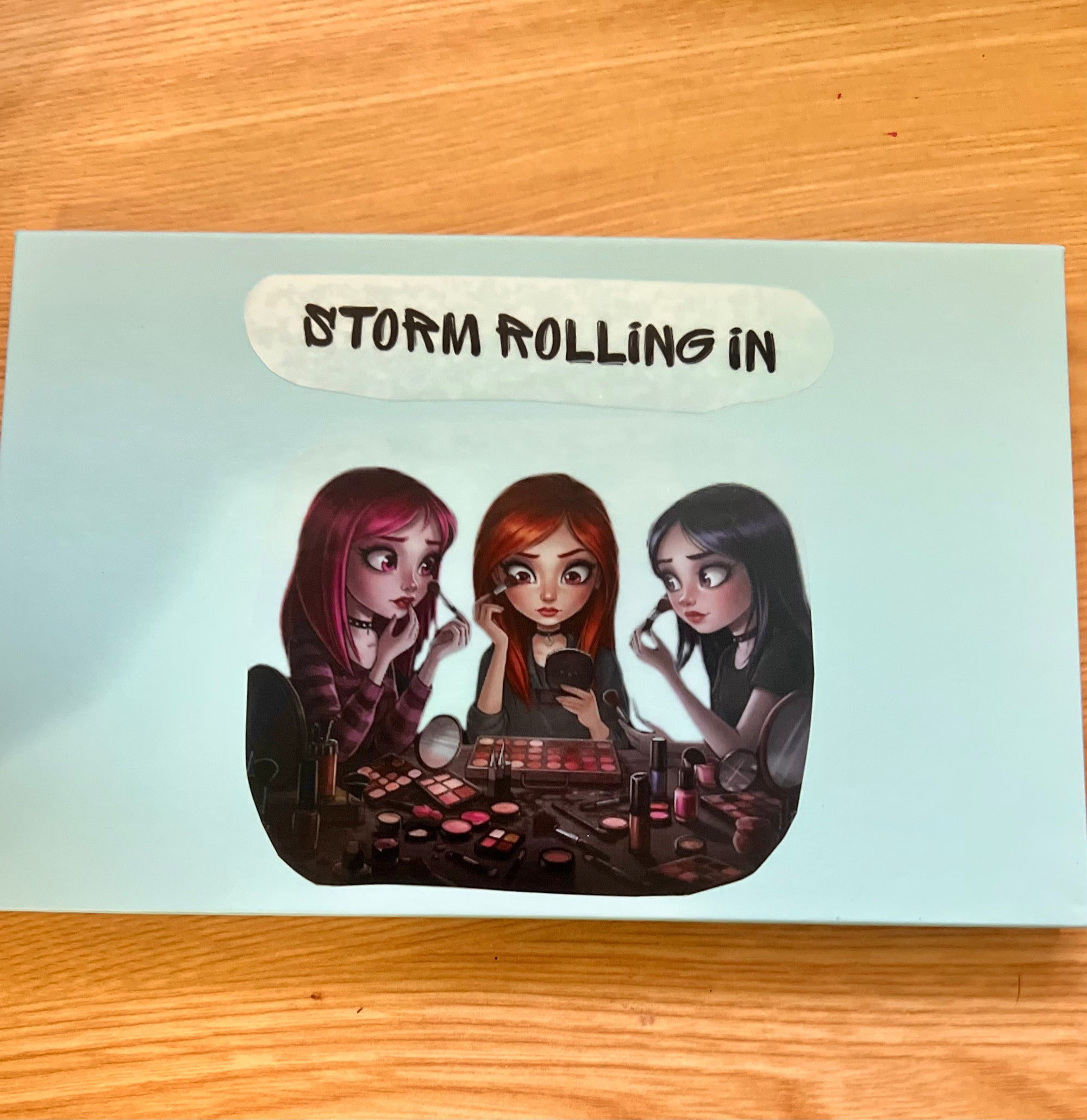 Vickipboutique ocean inspired makeup palette packaging with three animated girls applying eyeshadow